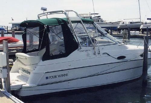 Atlantic Towers Arch installed on a Four Winns 258 Vista boat docked at a marina with other boats visible.