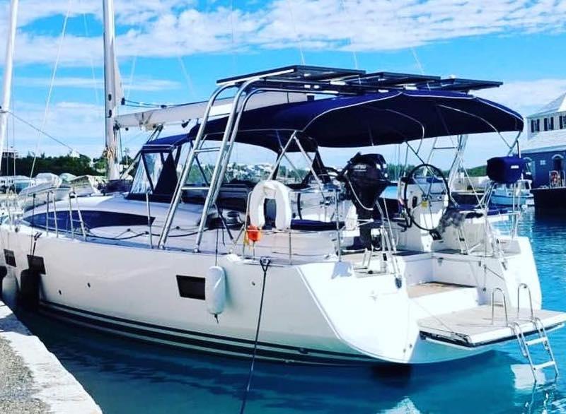 Atlantic Towers Arch installed on a Beneteau sailboat, docked in a marina with a clear blue sky.