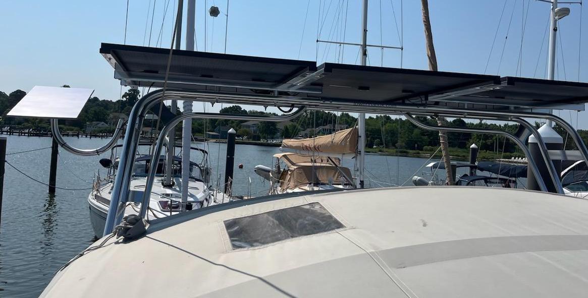 Atlantic Towers arch installed on a Bavaria Yachts boat with solar panels and marina background on a sunny day.