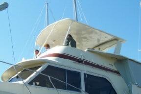 Uniflite 42 Double cabin boat with Atlantic Towers Top installed, showing canopy and upper deck with people on board