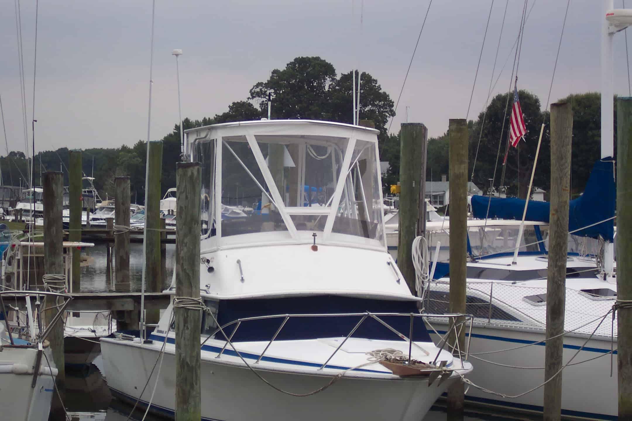 Atlantic Towers Top on a Bertram 28 Sport Fisherman at a marina, with boats and masts in the background.