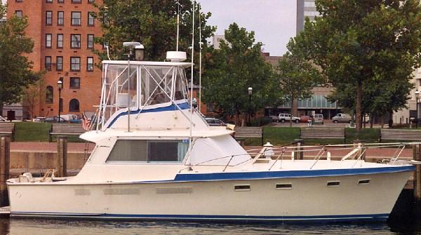 Atlantic Towers Top installed on Hattaras 42 Convertible docked near a waterfront with buildings and trees in the background
