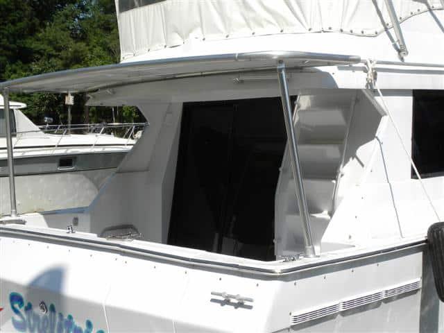Atlantic Towers Cockpit Sun Shade installed on a Mainship 35 Convertible boat, providing shade in the cockpit area.