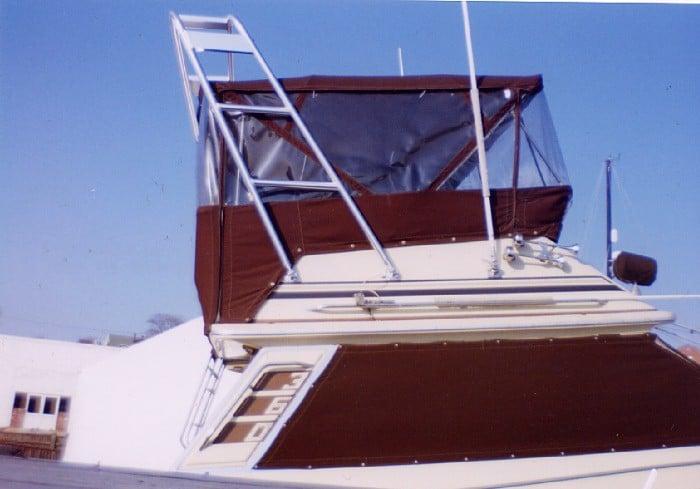 Atlantic Towers Arch on a Sea Ray 360 boat, featuring a brown canvas enclosure and aluminum structure against a blue sky.