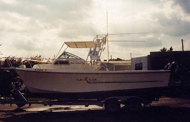 Atlantic Towers Top installed on a Sea Ox Blue Water boat, parked on a trailer with a cloudy sky.