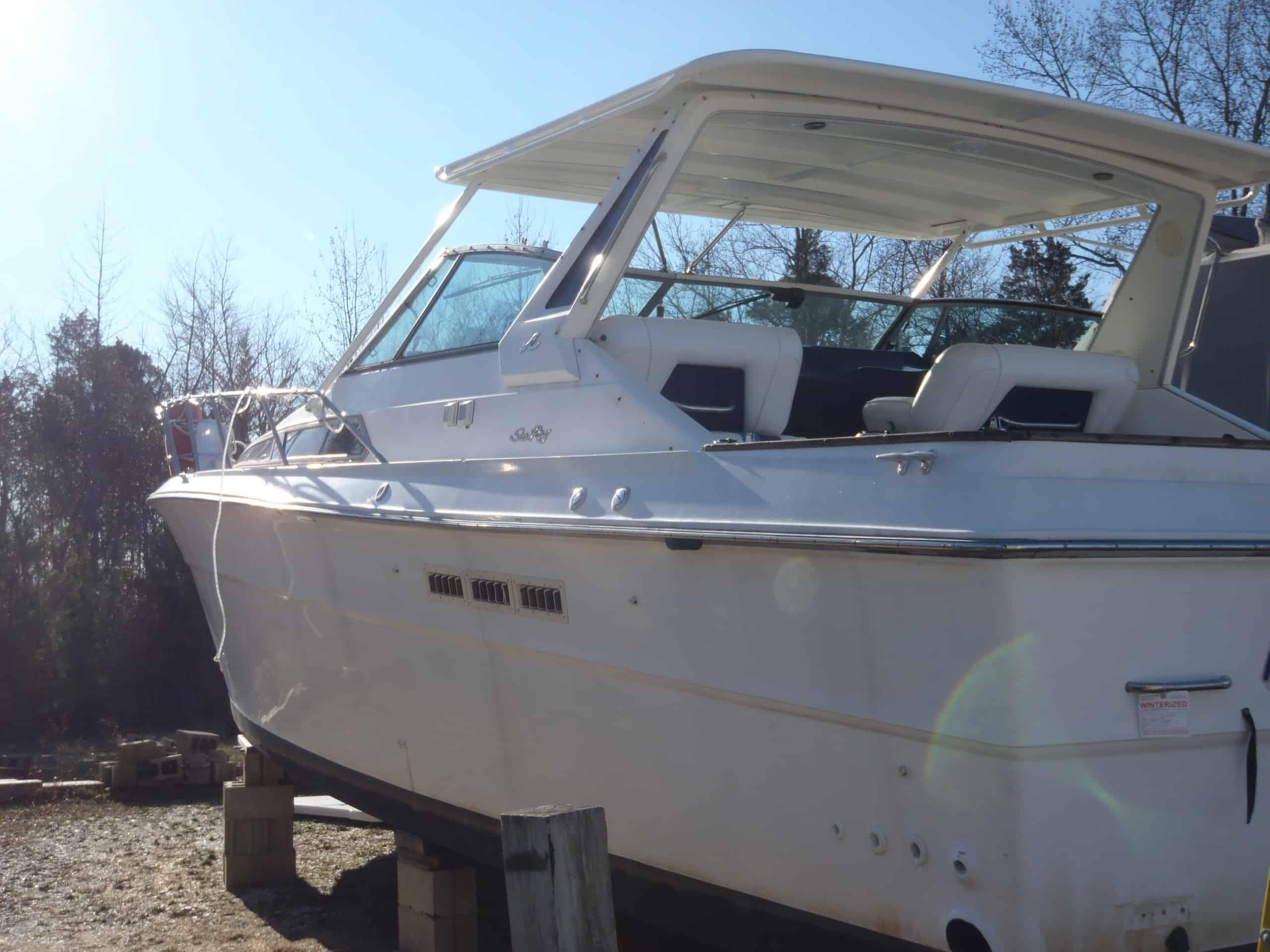 Atlantic Towers T-Top installed on a white boat, showcasing a clear sky and visible wooded backdrop.