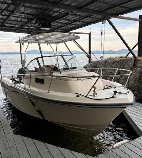 Atlantic Towers Top installed on a Grady White boat docked in a covered slip by the water.