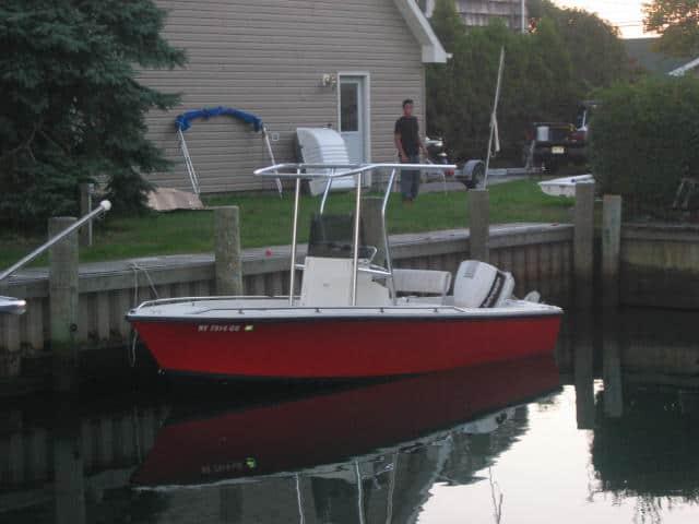 Atlantic Towers T-Top installed on a Sea Craft 18 boat, moored by a wooden dock.