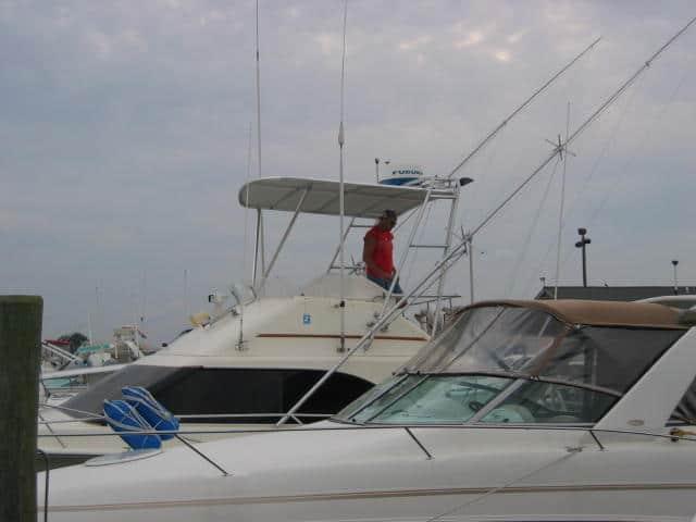 Atlantic Towers Top installed on an Ocean 32 SuperSport at a marina, with a person standing on the boat.