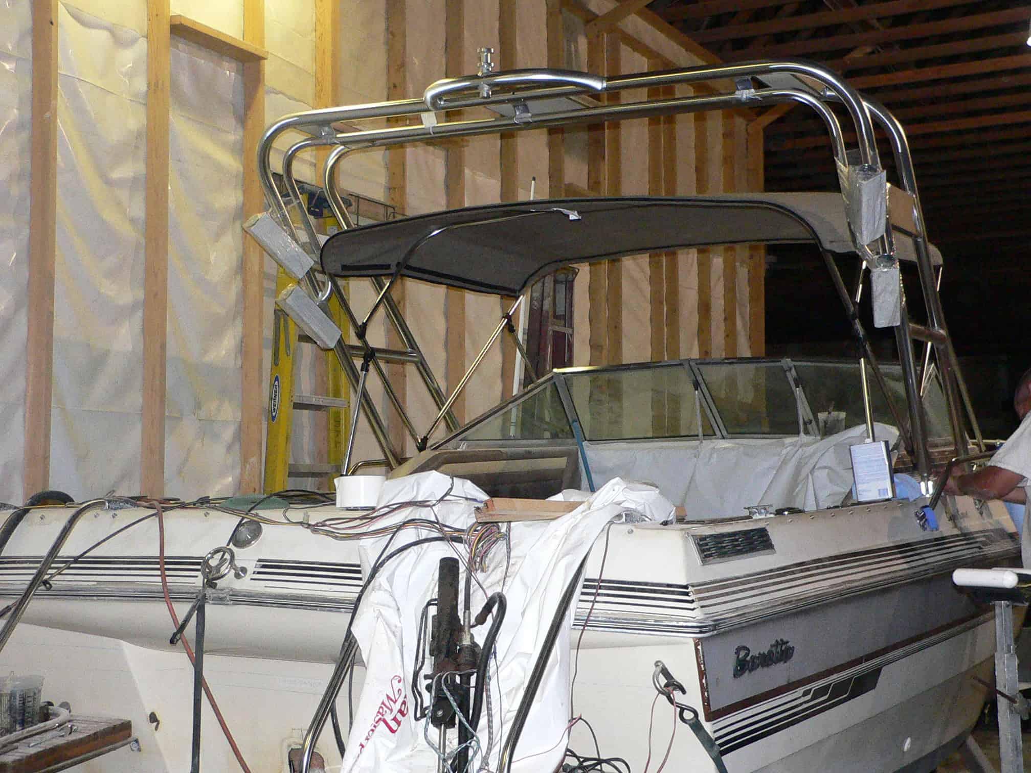 Atlantic Towers Arch installed on a Baretta 21 boat inside a wooden frame storage area with a cover partially removed.
