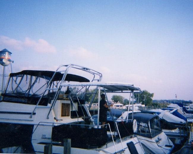 Atlantic Towers Aft Deck Top installed on Carver Aft Cabin boat docked in marina with multiple boats nearby.