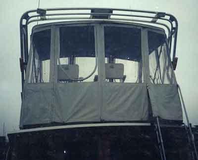 Rear view of Egg Harbor 33 Convertible boat with an installed Atlantic Towers Arch and enclosed canvas seating area.