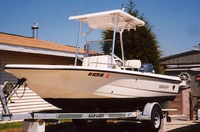 Atlantic Towers T-Top installed on a Century 1901 Bay Boat, parked on a trailer in a residential area.