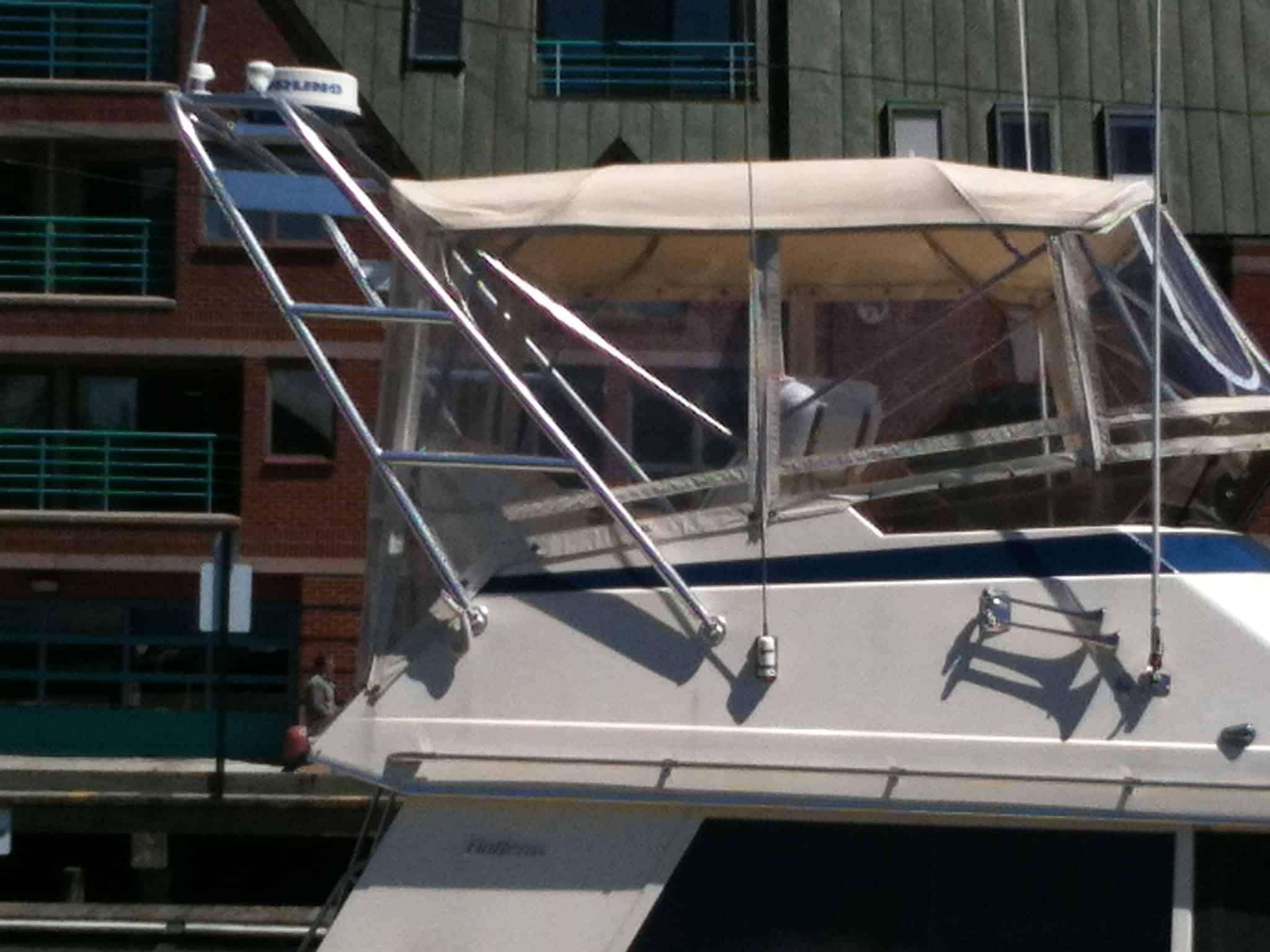 Atlantic Towers arch installed on a Hatteras 36 Convertible boat, featuring aluminum construction and protective canvas.