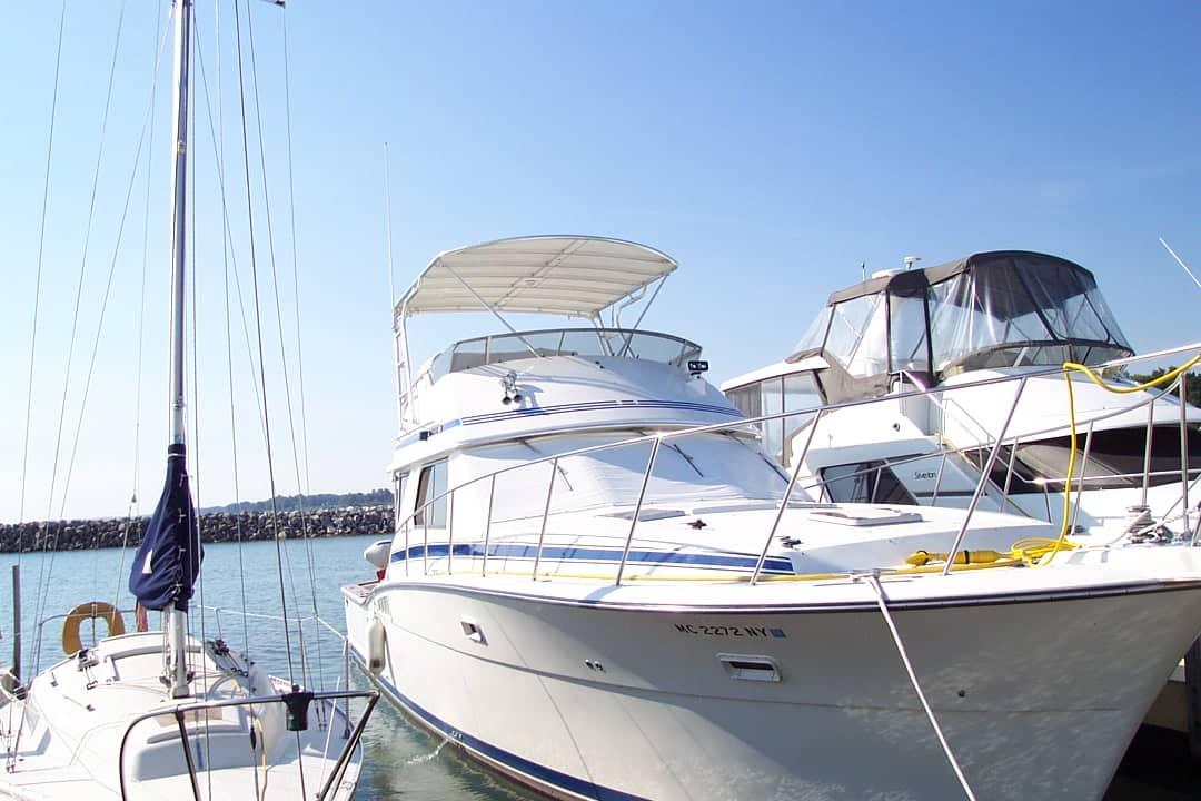 Atlantic Towers Top installed on a Chris Craft 422 Convertible boat docked at the marina with other boats nearby.