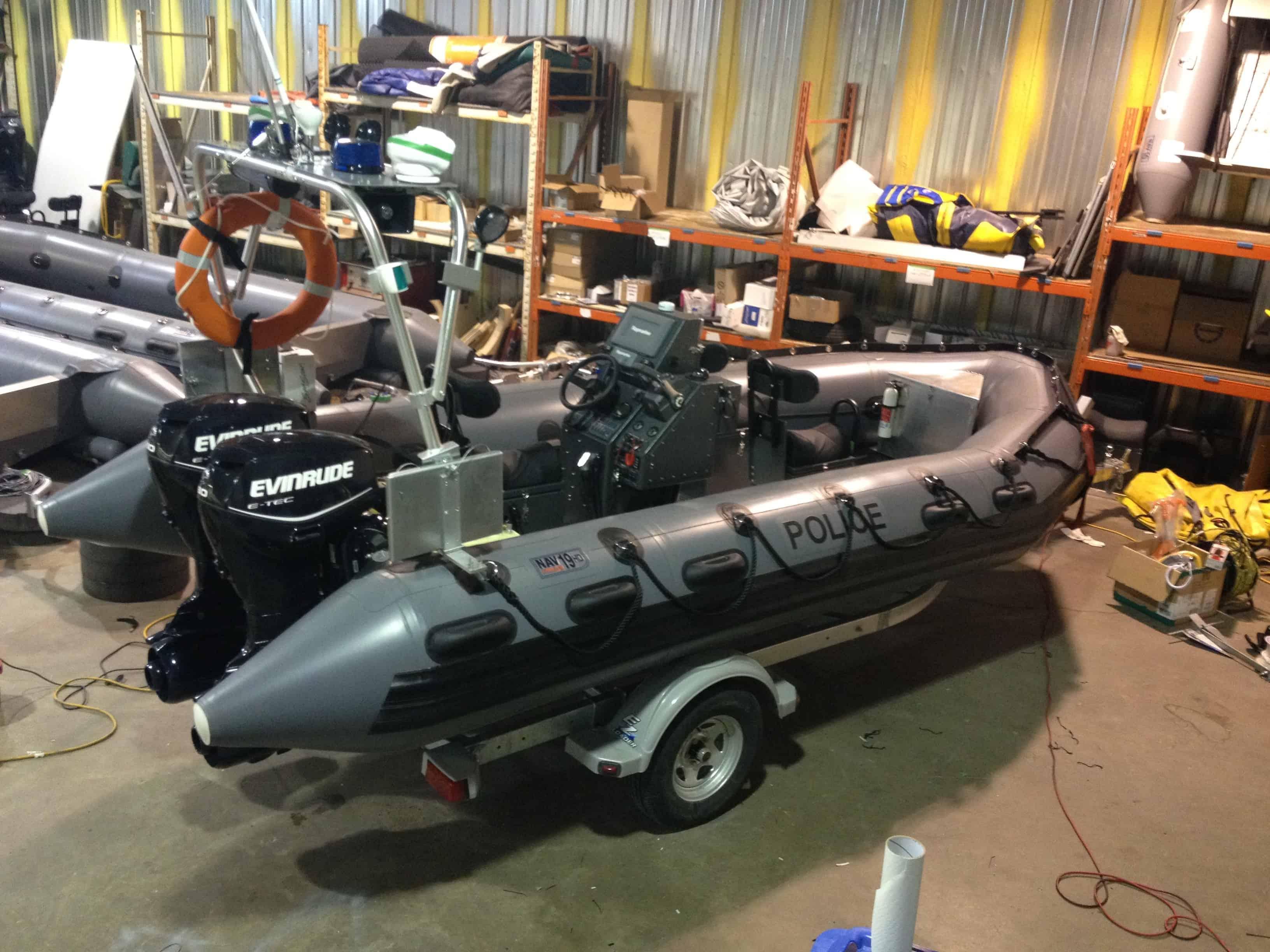 Atlantic Towers Arch mounted on a police rib boat, showcasing the interior and equipment in a workshop setting.