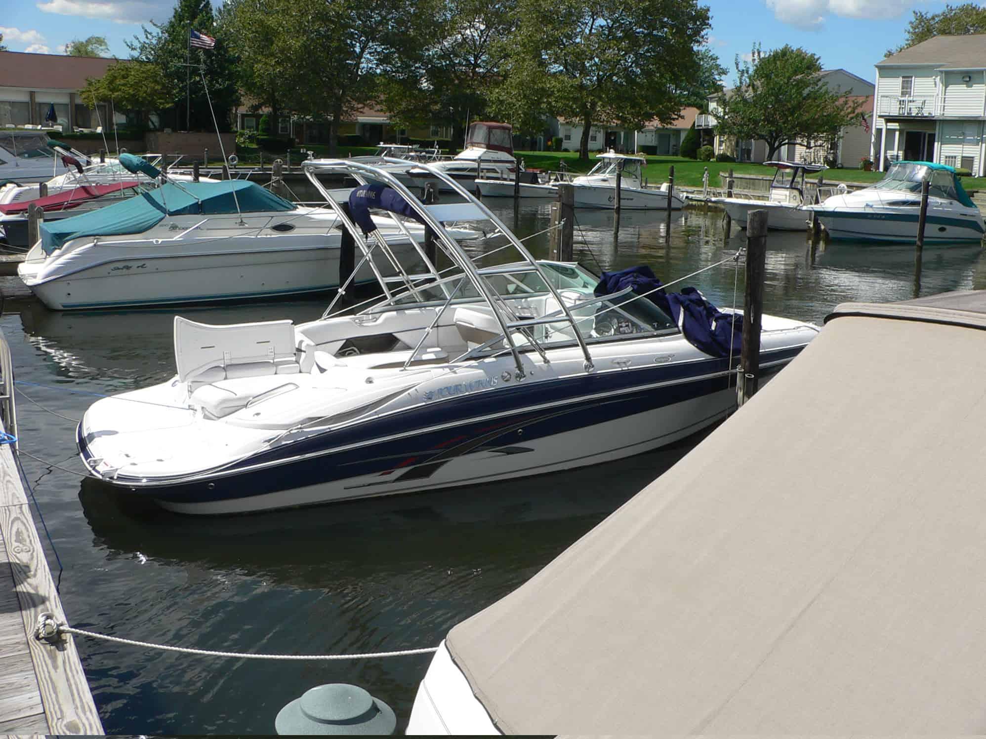 Four Winns 240 Horizon boat equipped with an Atlantic Towers Arch, docked in a marina.