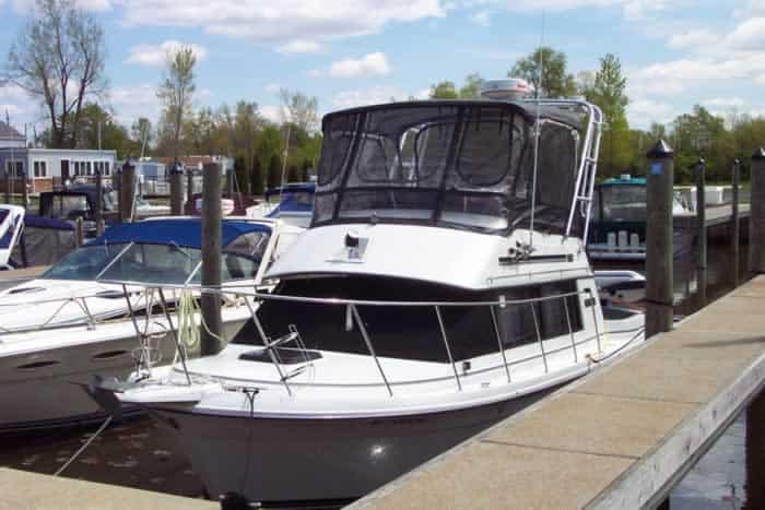 Atlantic Towers arch installed on a Carver Mariner boat docked at a marina on a sunny day.
