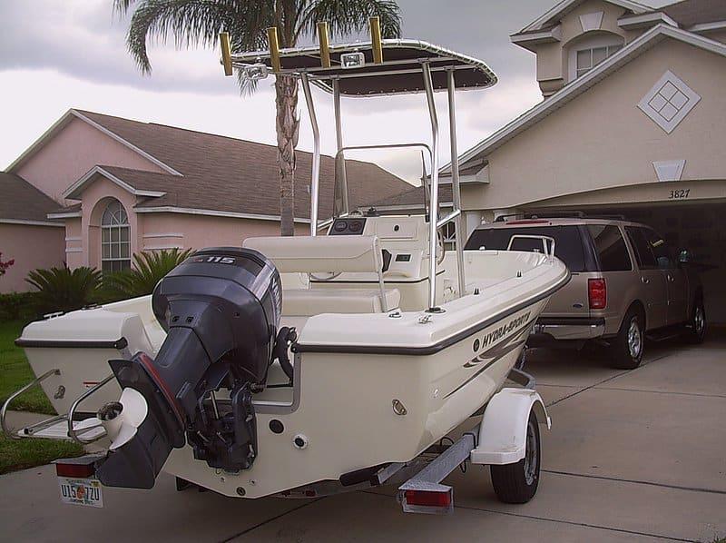 Hydra Sports 180 boat with Atlantic Towers T-Top and 115 HP outboard motor on a trailer in driveway