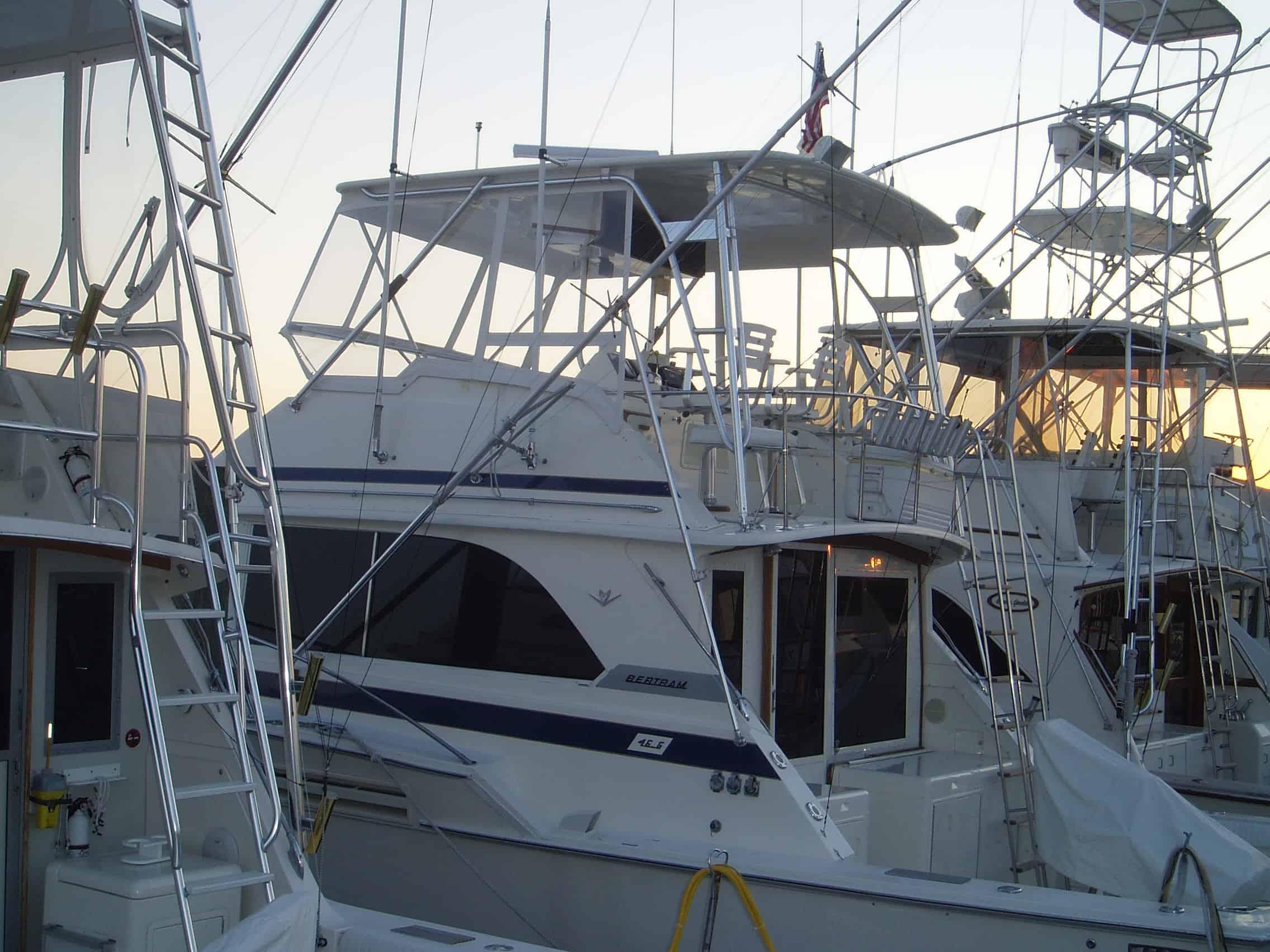 Atlantic Towers Top installed on a Bertram 46 Convertible boat docked at a marina, surrounded by other vessels.