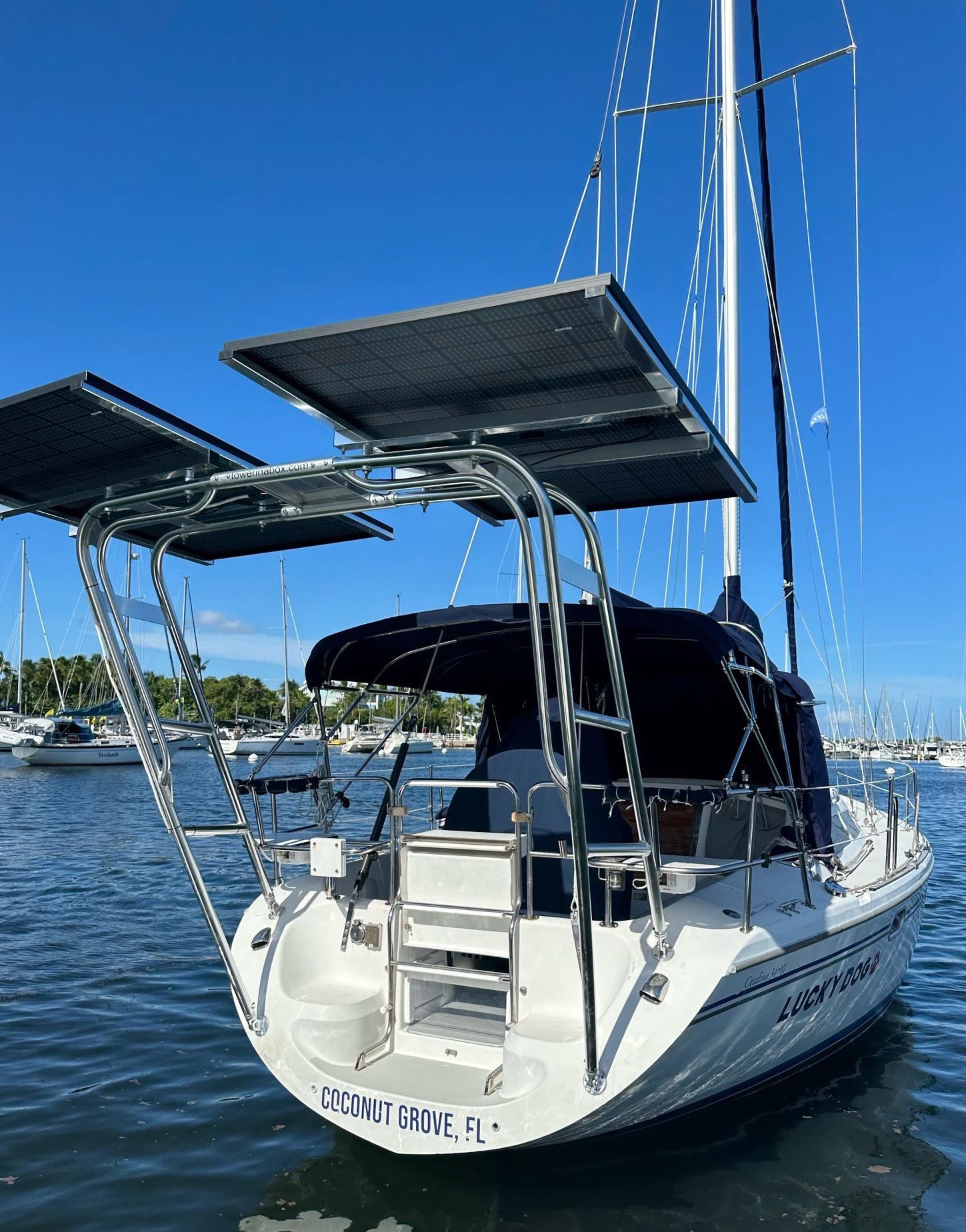 Atlantic Towers Arch installed on a Catalina boat, featuring solar panels and moored at Coconut Grove, FL.