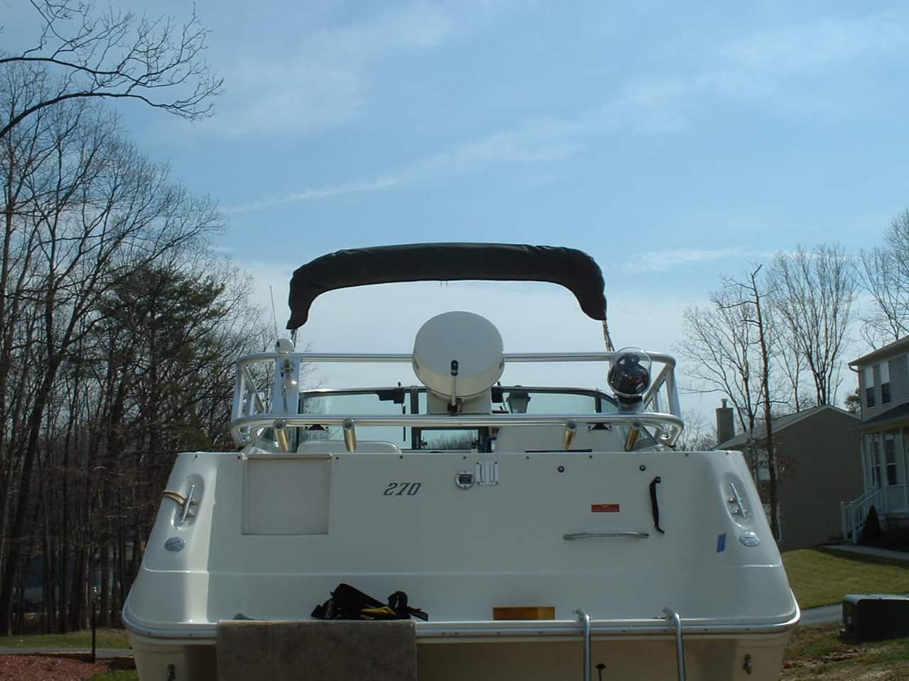 Atlantic Towers Arch installed on a Sea Ray 270 Weekender boat, viewed from the stern with trees and homes in the background.