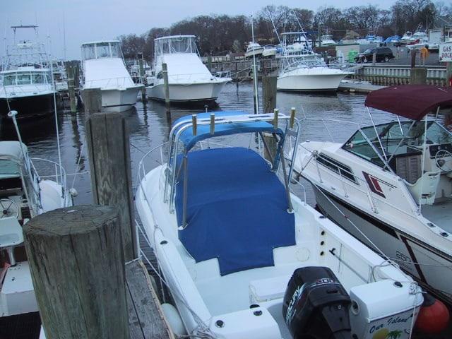 Atlantic Towers arch installed on a Pro Line 22 W/A boat at a marina with multiple vessels docked.