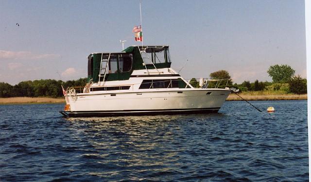 Atlantic Towers Top installed on a Trojan 36 Tri-Cabin Trawler anchored in calm waters.
