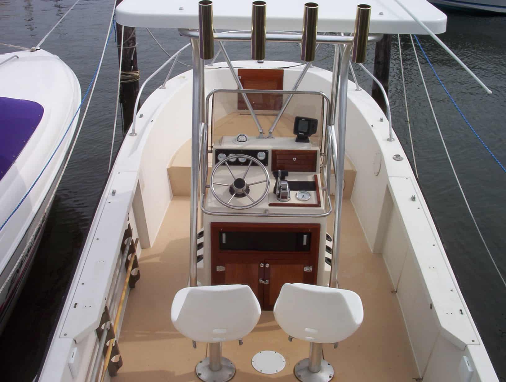 Atlantic Towers T-Top installed on Wellcraft Center Console boat with steering wheel and two white seats at dock
