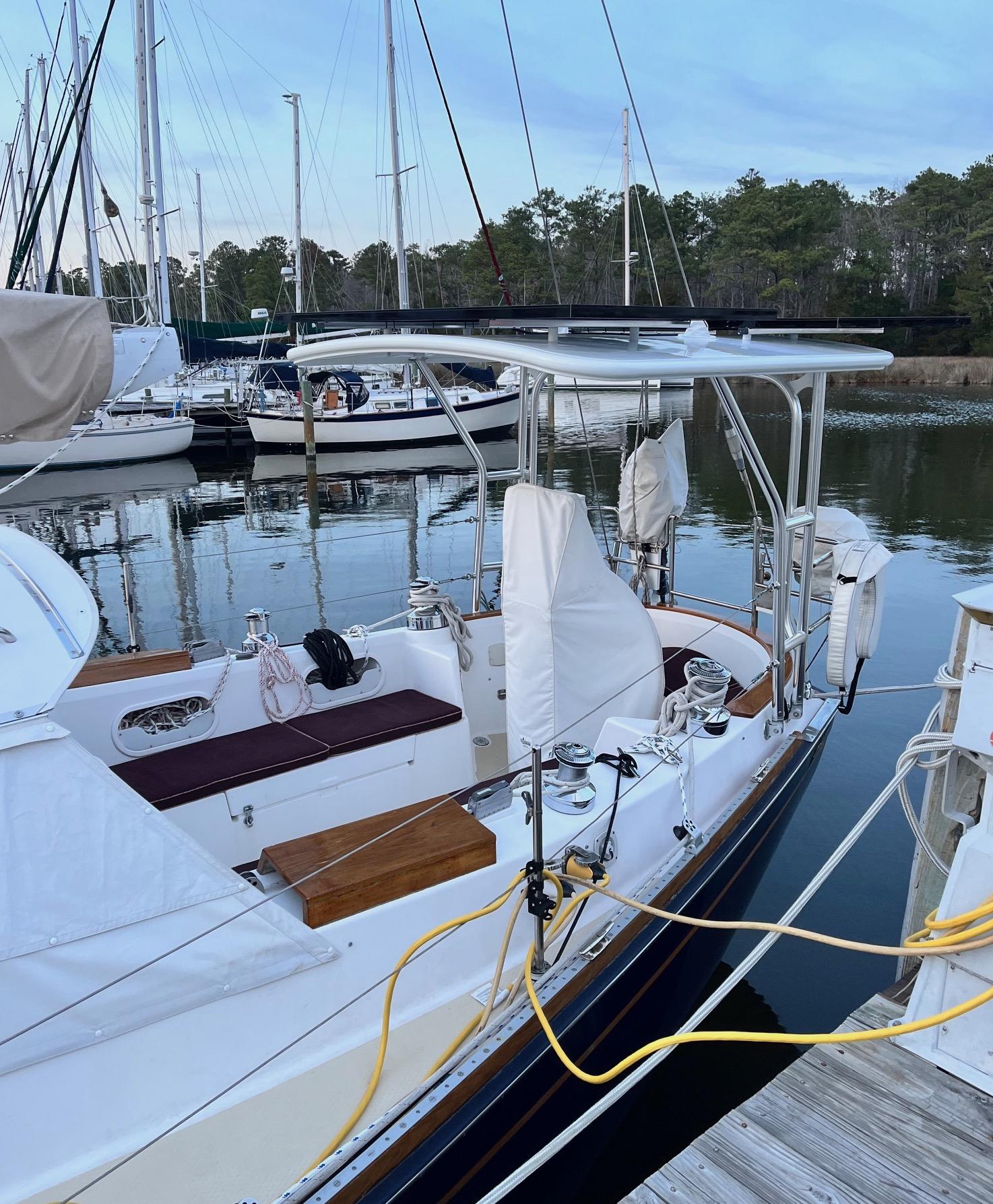 Atlantic Towers Top installed on a Shannon boat at a marina, reflecting in calm waters with nearby sailboats.