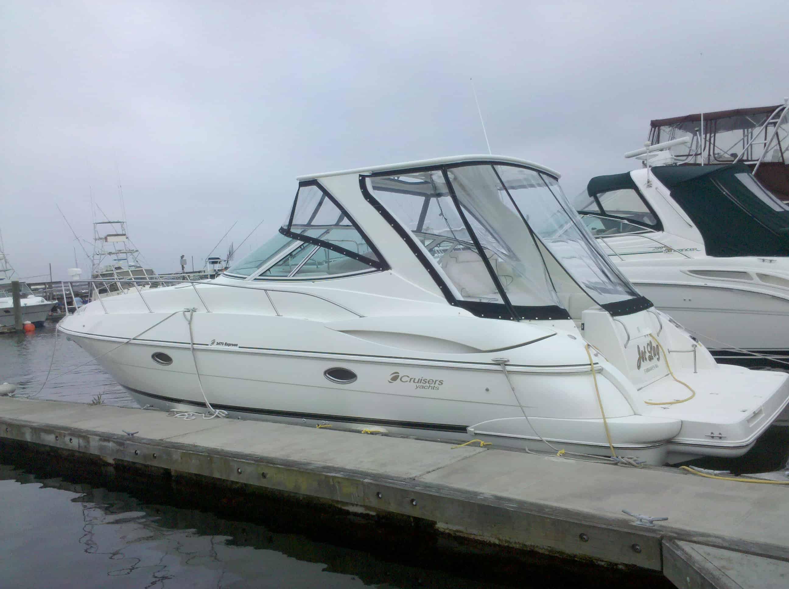 Atlantic Towers Top installed on a Cruisers 340 Express boat docked at a marina, with cloudy skies above.