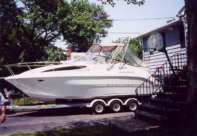Atlantic Towers Arch installed on a Bayliner 2655 Cierra boat, located near a residential area.