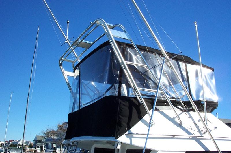 Atlantic Towers Arch installed on a Phoenix 33/34 SFX boat with enclosed upper deck and clear vinyl windows.