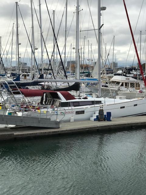 Atlantic Towers Arch installed on a Beneteau boat docked at a marina with numerous sailboats in the background.