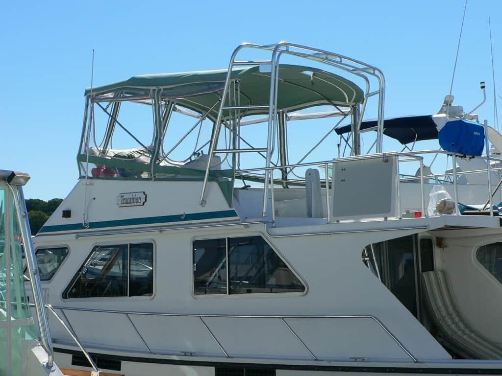Provincial Marine 42 Trawler boat equipped with Atlantic Towers Arch and green canopy docked on a clear day.