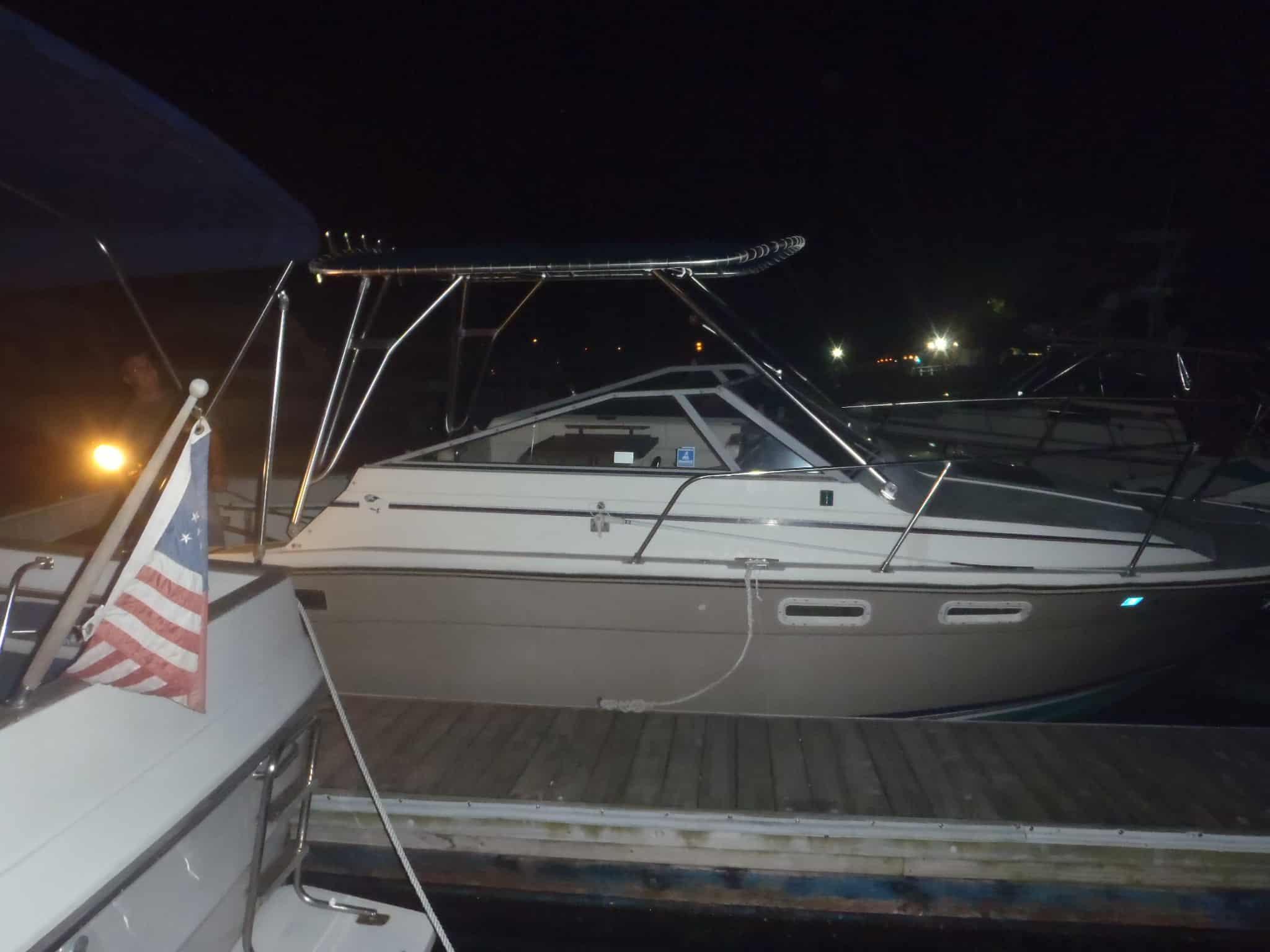 Bayliner 2860 Fisherman boat docked at night with Atlantic Towers Top frame installed on the deck.