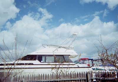 Atlantic Towers Air Tower installed on a Mainship 35 Convertible boat, featuring a cloudy sky in the background.