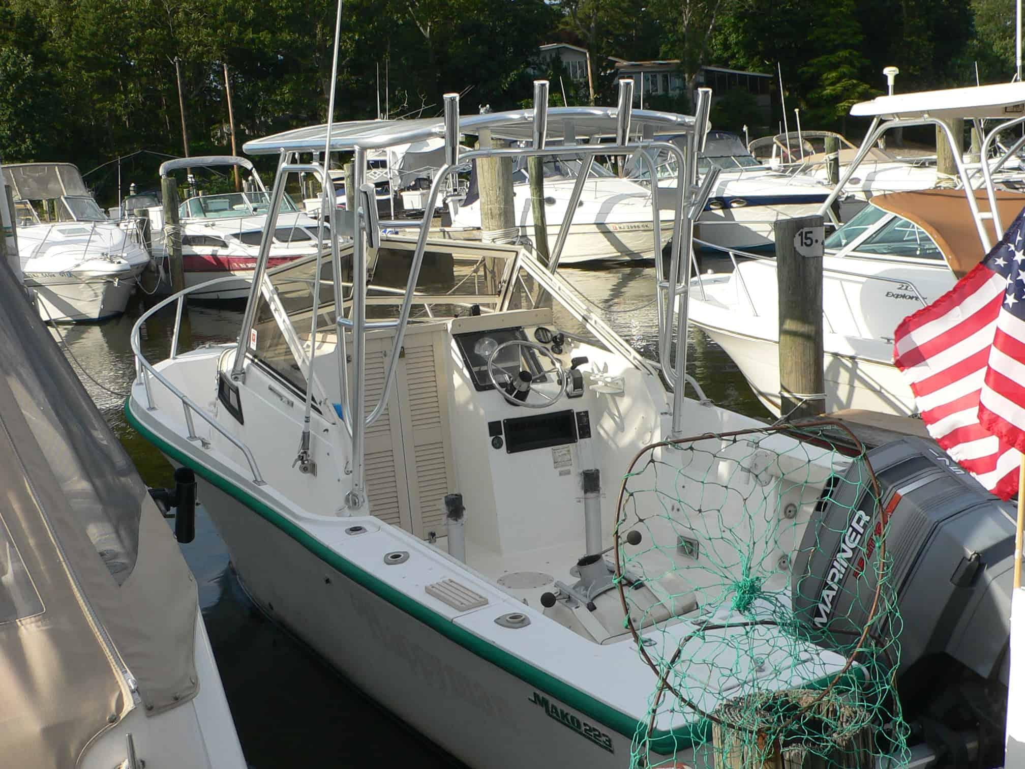 Atlantic Towers Top mounted on a Mako 223 Walkaround boat docked among other boats with fishing gear and an American flag.