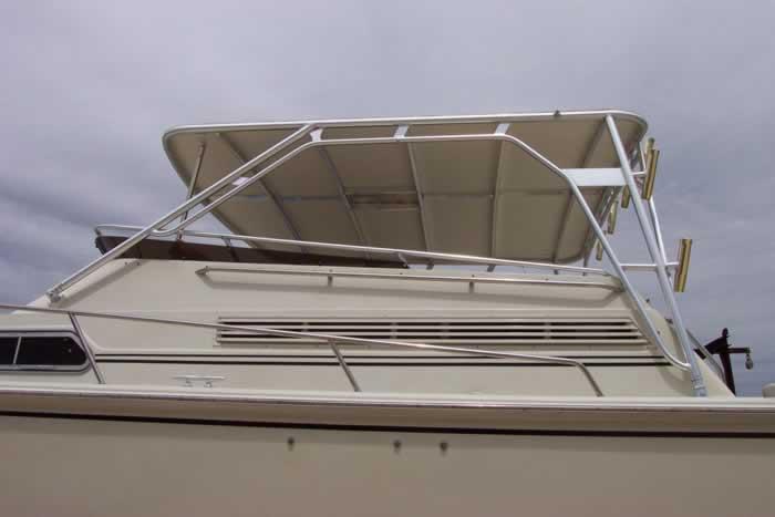 Side view of a Boston Whaler boat with an installed Atlantic Towers Top featuring a white canopy and aluminum frame.