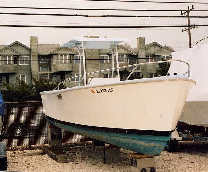 Atlantic Towers T-Top installed on a Wahoo 26 Console boat, parked in a marina with buildings in the background.