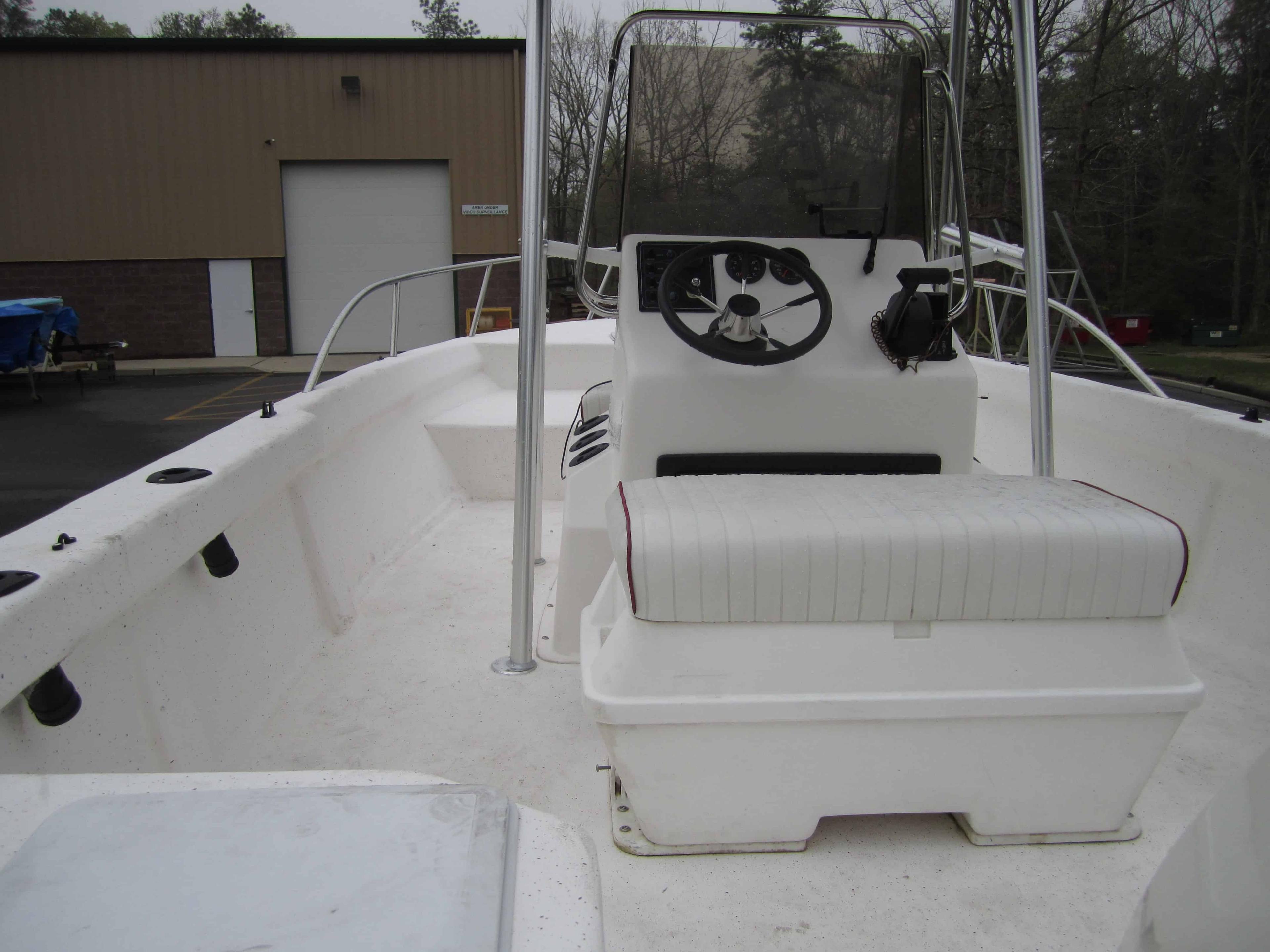 Atlantic Towers T-Top installed on a Cape Craft 19 center console boat on calm water near a dock.