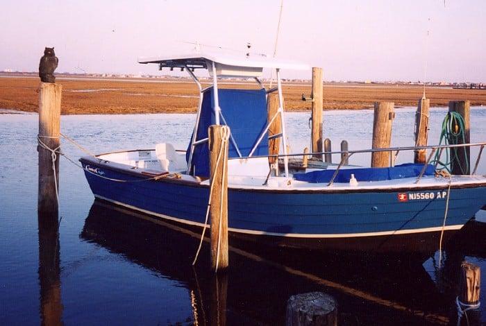 Atlantic Towers T-Top on a Chris Craft Cape Dory boat docked next to wooden pilings at sunset.