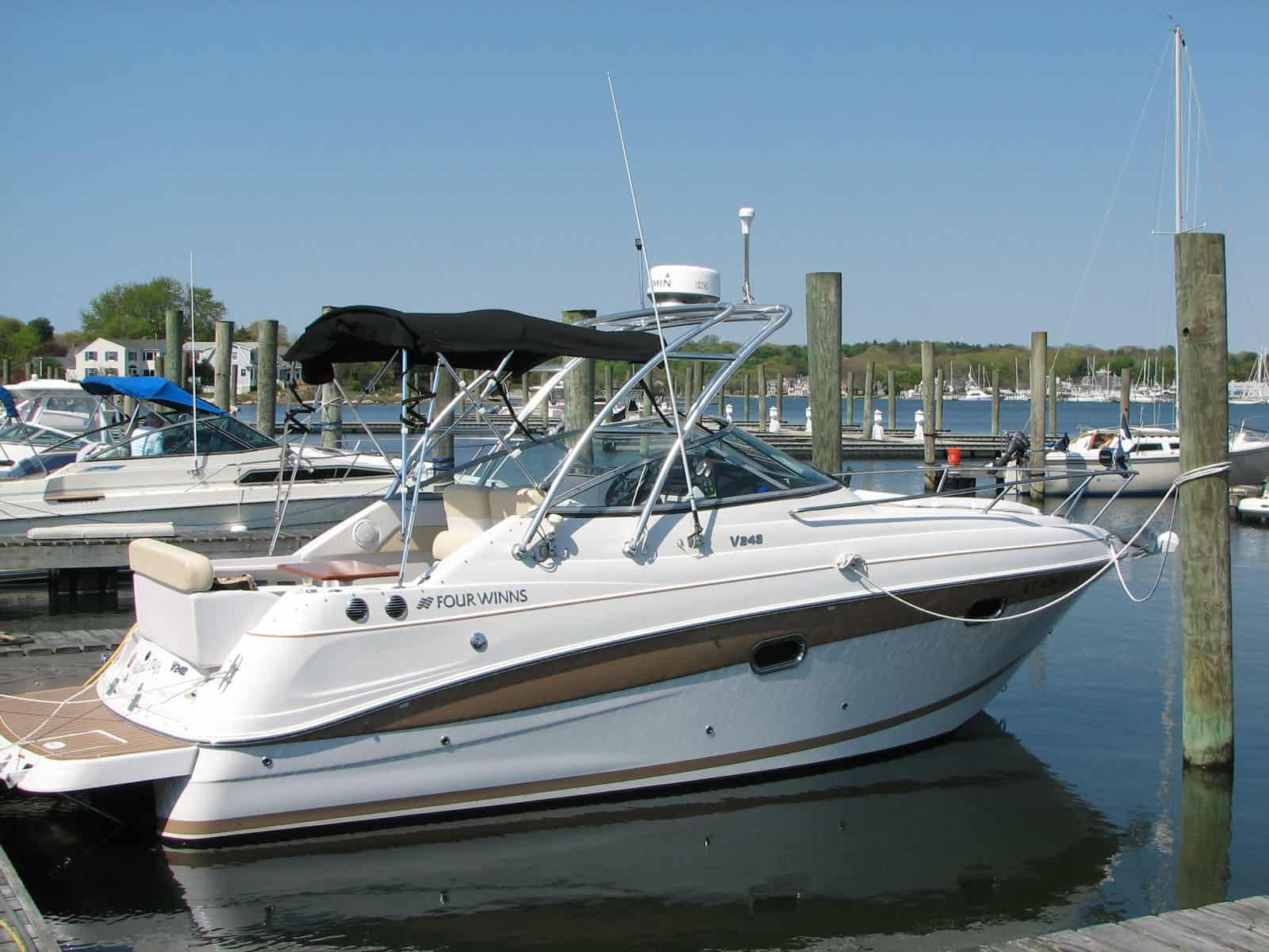 Atlantic Towers arch installed on a Four Winns 248 Vista cruiser boat shown from the side on water.