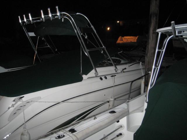 Atlantic Towers Top arch with rod holders installed on a boat docked at night with green canvas covers.