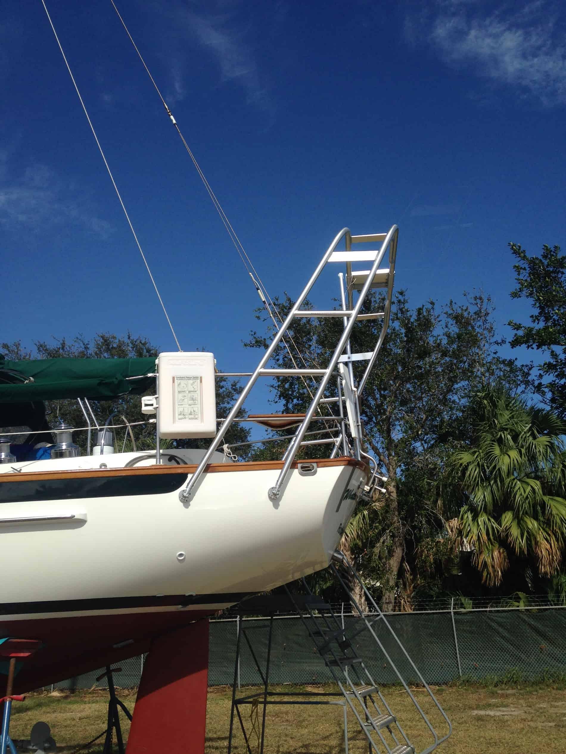 Atlantic Towers Arch installed on the stern of a Cabo Rico boat, showcasing metal construction against a blue sky.