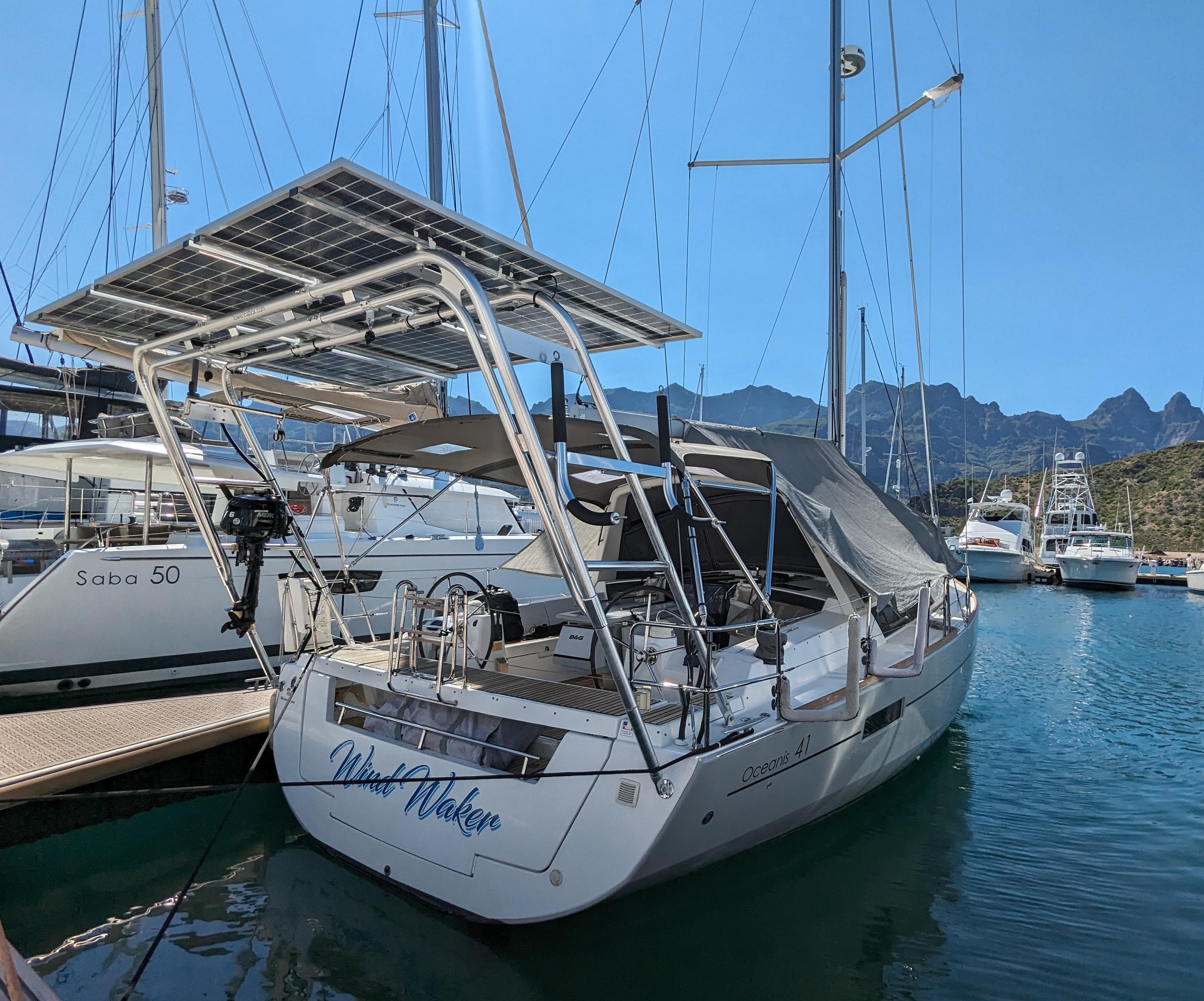 Atlantic Towers arch installed on a Beneteau boat at harbor, featuring solar panels and surrounding boats in a scenic view.