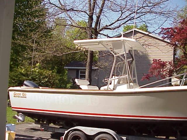 Atlantic Towers T-Top installed on a Master Marine Good Go boat, positioned on a trailer in a yard.