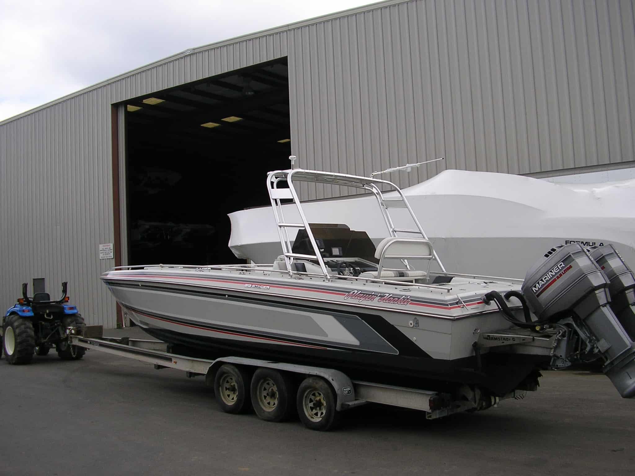 Atlantic Towers arch installed on a Chris Craft 313 Stinger center console boat resting on water near docks.
