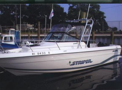 Atlantic Towers Arch installed on a Seaswirl 2150 Striper walkaround boat shown on calm water.
