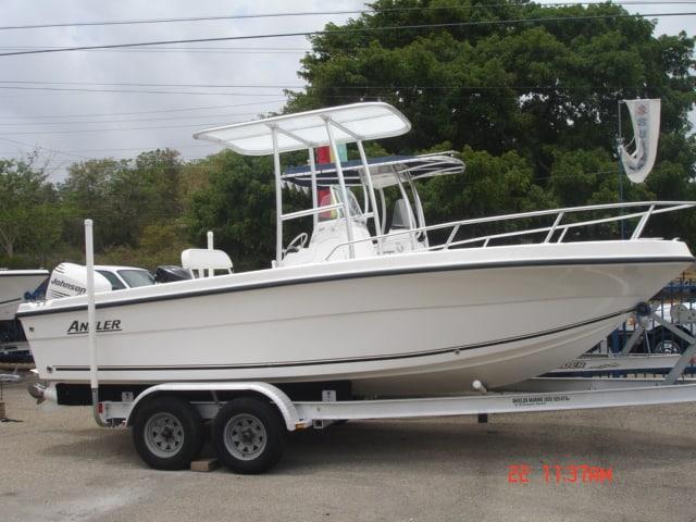 White Angler Boats model on trailer with Atlantic Towers T-Top mounted above the console under cloudy sky.
